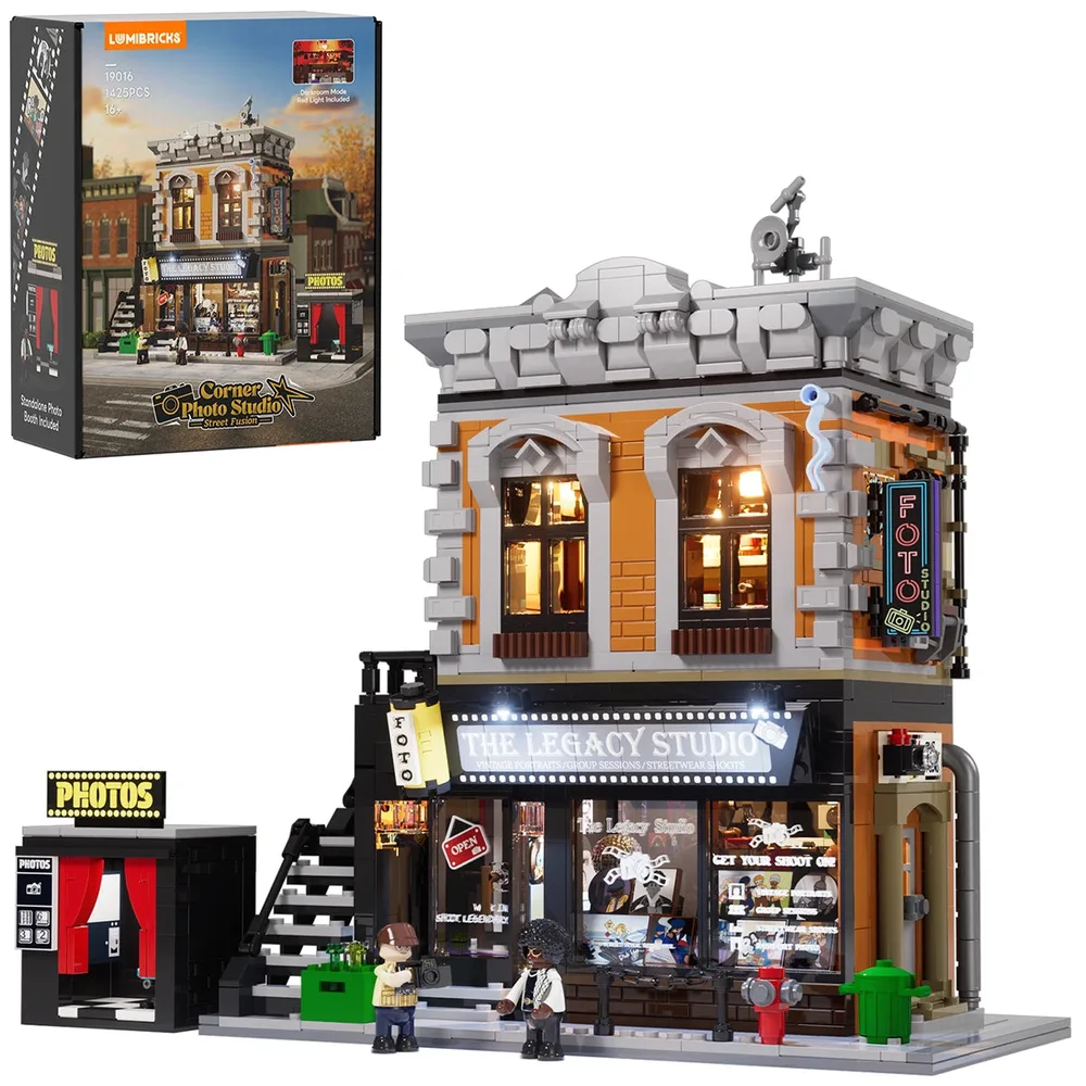 Lumibricks Corner Photo Studio 19016 set box next to the fully assembled, lit model. The model features an orange and gray building, a black exterior staircase, and a photo booth structure. Two minifigures stand on the sidewalk. The box displays set number, piece count, and dimensions.