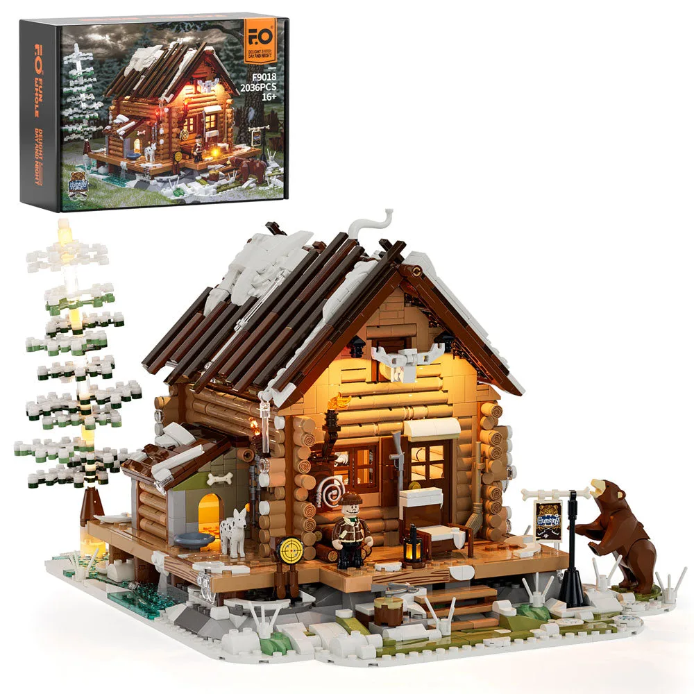 A lighted LEGO-style hunting cabin set, Lumibricks F9018, with 2036 pieces on a snowy baseplate, showing a bear figure and a hunter minifigure. The product box is visible in the upper left corner.
