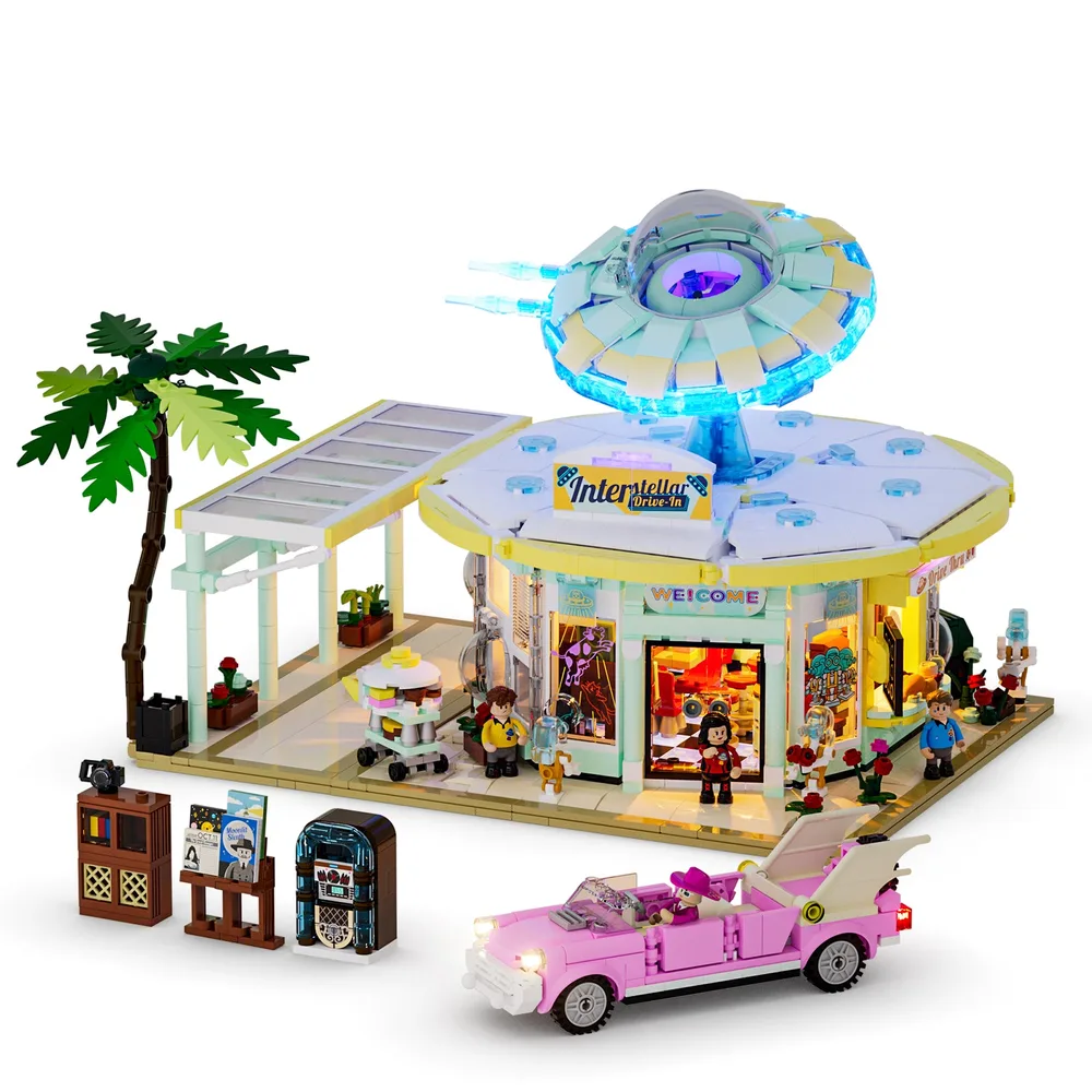 A bright, well-lit image of the Lumibricks Interstellar Drive-In set, featuring a mint green and yellow diner, a hovering blue-lit UFO, a pink convertible, a palm tree, and several minifigures on a white background.