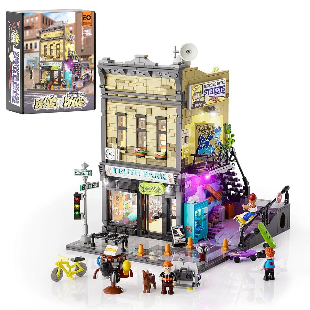 Full view of the Lumibricks F9051 Skate Shop set, showing the building with its detailed exterior, minifigures, street accessories, and illuminated elements. The set's box art is visible in the upper left corner.