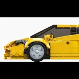 Side profile of the yellow brick car model.
