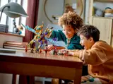 Children joyfully playing with the Arc Dragon set on a wooden table.