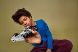 Kid holding LEGO Audi F1 Race Car