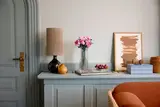 Roses in vase, living room setting.