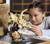 Child holding LEGO Triceratops Skull.