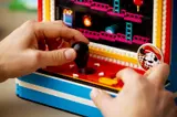 Hands playing Donkey Kong Arcade.