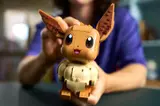 Hands holding LEGO Eevee.