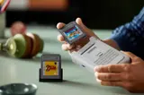 Inserting Game Pak into Game Boy.
