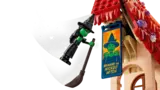 Elphaba flying past banner.