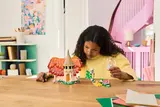 Child playing with LEGO Wicked.