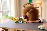 Person playing with set on table.