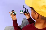 Child playing with LEGO motorcycle and streetlamp.