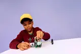 Child playing with LEGO Harry Potter set.