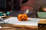 Finished LEGO pumpkin with ghost on display.
