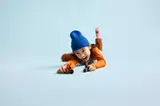 Child playing with LEGO Ninjago bikes.