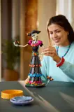 Woman admiring LEGO La Catrina model.