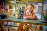Child playing with Luna Lovegood's House.