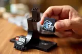 Placing 25th anniversary tile on Lego Falcon stand.