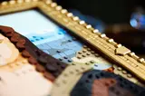 Gold frame and background detail.
