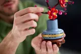 Adjusting a Plum Blossom flower.
