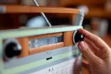 Turning the radio dial.