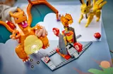 Child playing with LEGO Charizard and arena.
