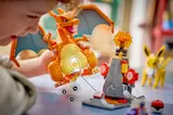 Child interacting with LEGO Charizard.
