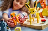 Girl playing with Charmander and Smart Brick.