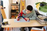 Person posing Spider-Man Hero Figure.