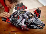 Child playing with Lego Dark Falcon 75389.