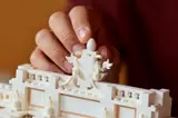Builder places finial.