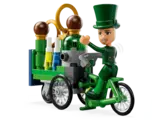 Lego minifigure on a green tricycle.