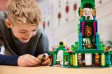 Boy smiling while playing with Lego Emerald City.