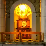 Illuminated chandelier and distant clock.