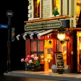 Awning, street lamp, and flowers illuminated.