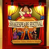 Close-up of illuminated Shakespeare Festival poster.