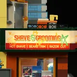 Backlit 'SHAVE & GROOMING' sign.