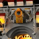 Close-up of illuminated castle crest and drawbridge.