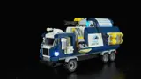 Lit 'Urban Restore' truck in darkness.