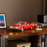 Low rider on desk, headlights glowing.