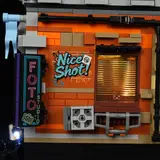 Side wall with neon sign and lit window.