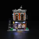 Lit studio facade at night, full front.