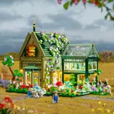 House and greenhouse, lights on in daylight.