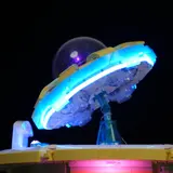 Close-up UFO, blue glow.