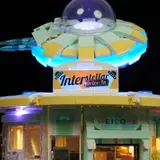 Main sign lit, UFO above.