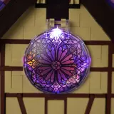 Close-up of backlit circular stained glass window in Lumibricks Retro House 10014.
