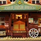 Close-up of the lit 'Gold Rush Hotel' entrance.