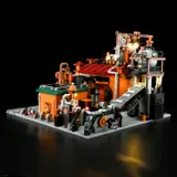 Angled rear view of lit factory, conveyor belt.