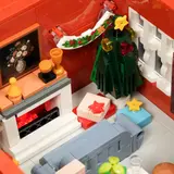 Living room, lit fireplace, tree.