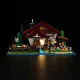Shepherd's Cottage illuminated at night.